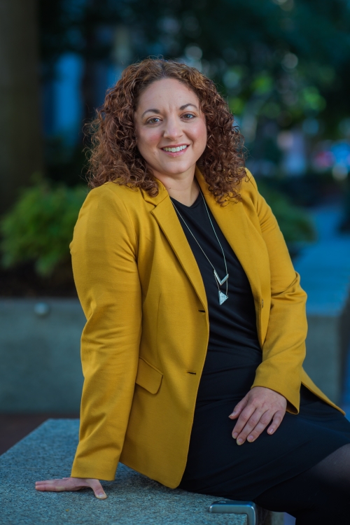 Olivia Corradin wears a yellow blazer 