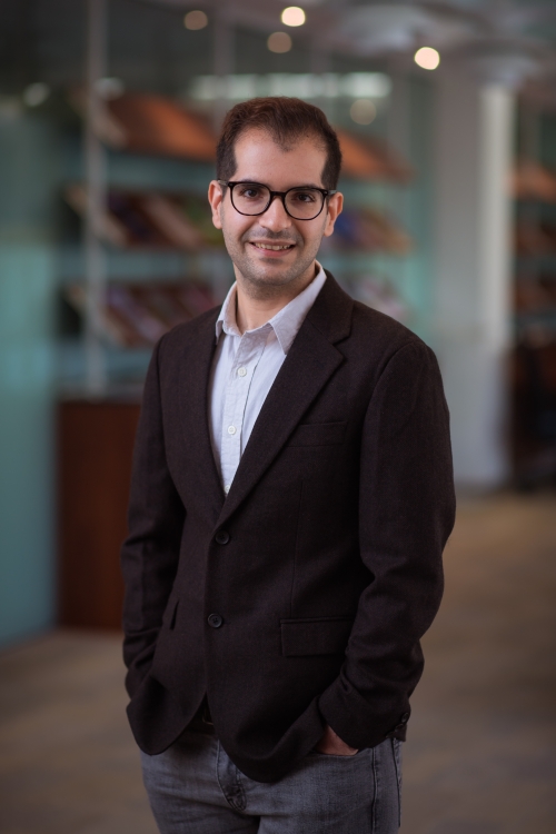 Arash stands in a lab