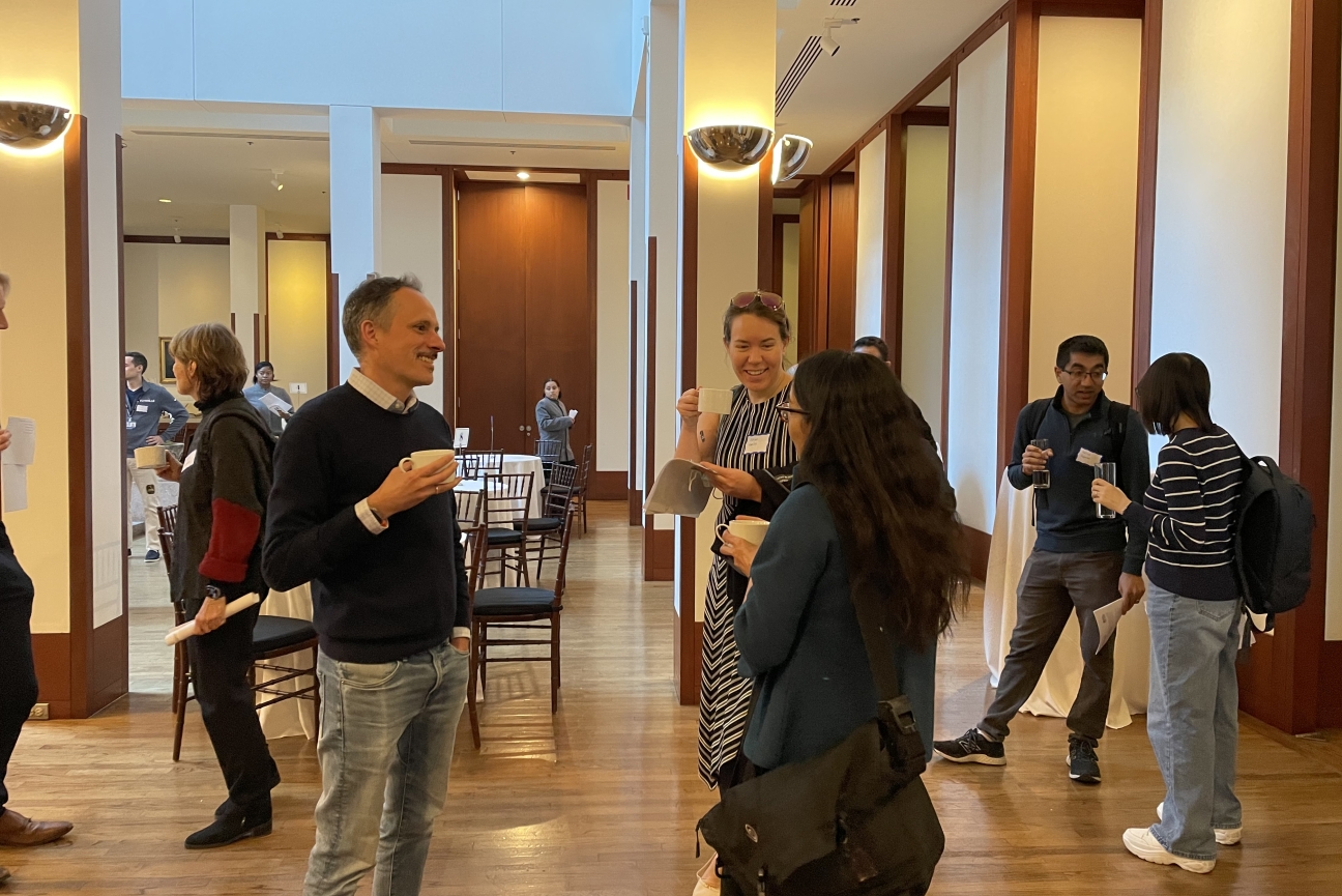 People in a conference space talking in small groups