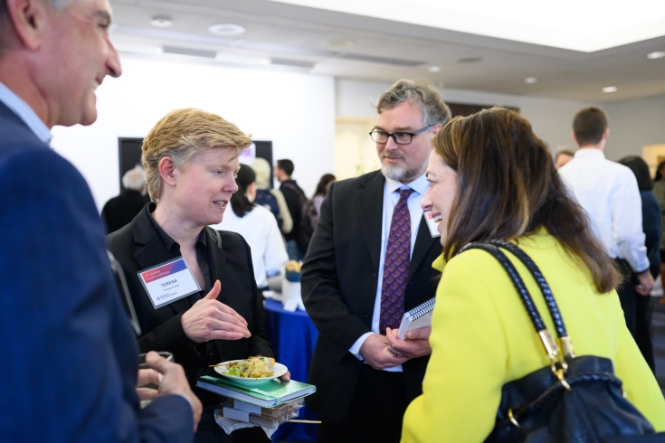 A group of attendees chat at the reception